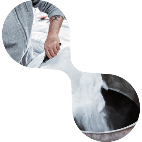 Eine Person schüttet thermoplastisches Klebstoffpulver in einen Kessel | Abifor